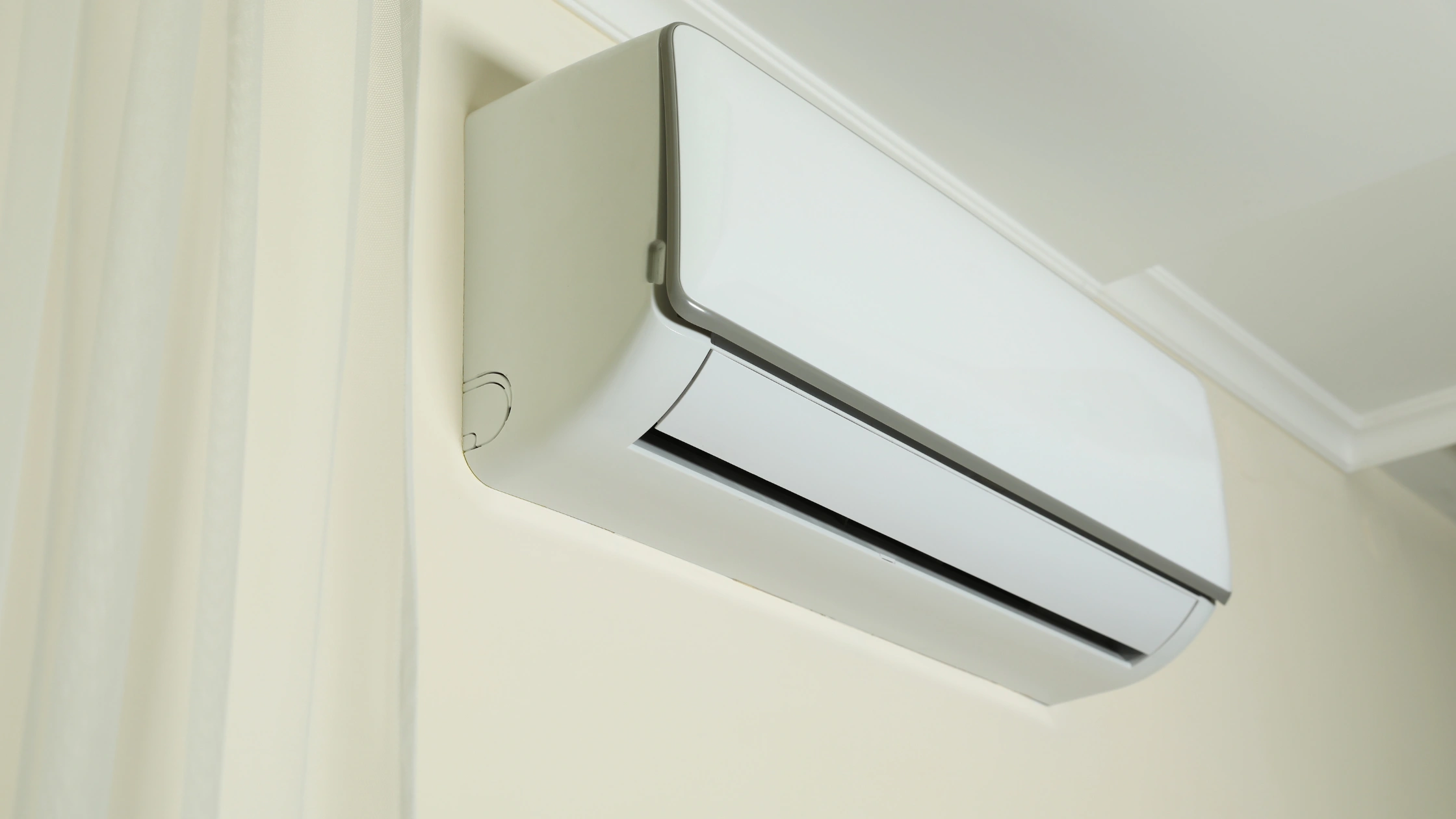 White Mini Split Indoor Air Handler Unit Mounted on Home Wall Florida