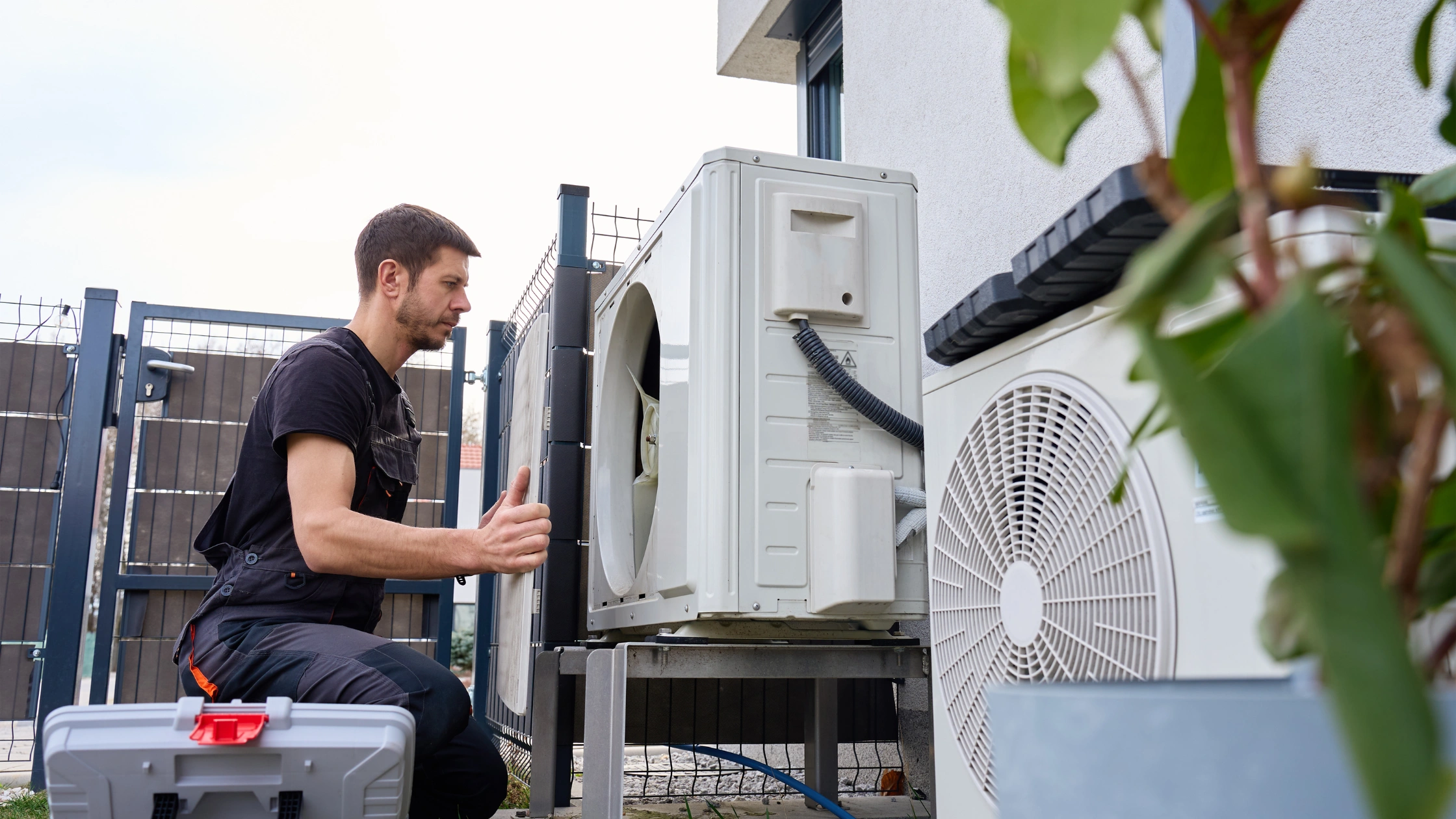 HVAC Technician Inspecting Outdoor Heat Pump Unit During Preventive Maintenance